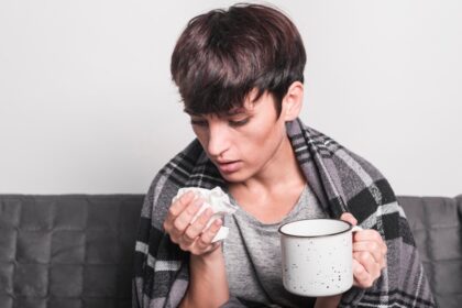 sick-woman-holding-coffee-mug-sneezing-tissue-paper_23-2147889110
